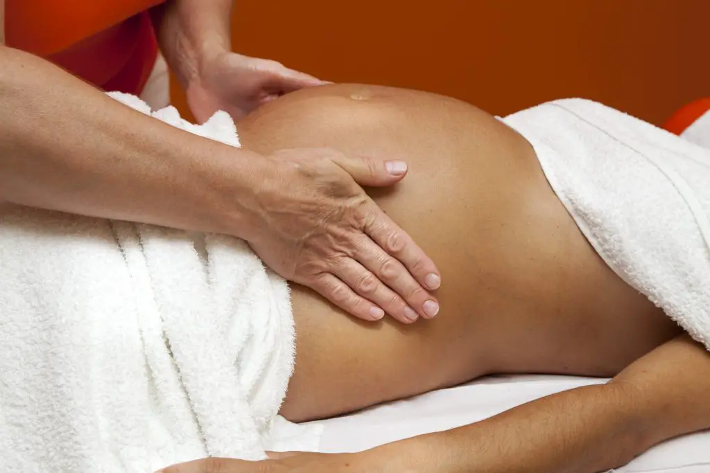 prenatal massage therapy on young Latin woman