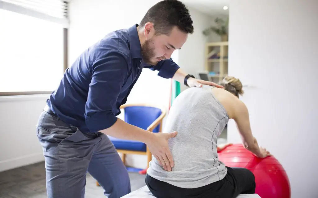 physiotherapist treating joint pain lower back