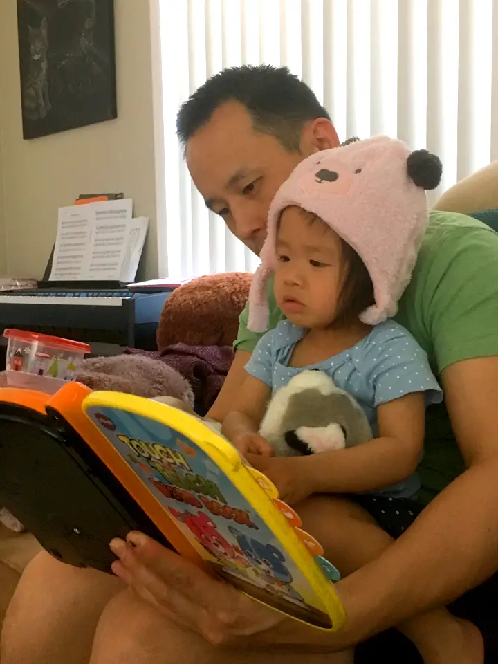 father reading with his daughter