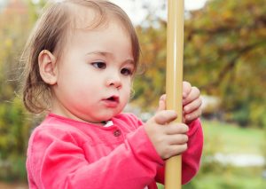 young girl playing in autumn