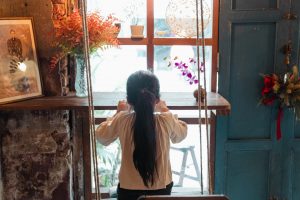 anxious girl looking out a window