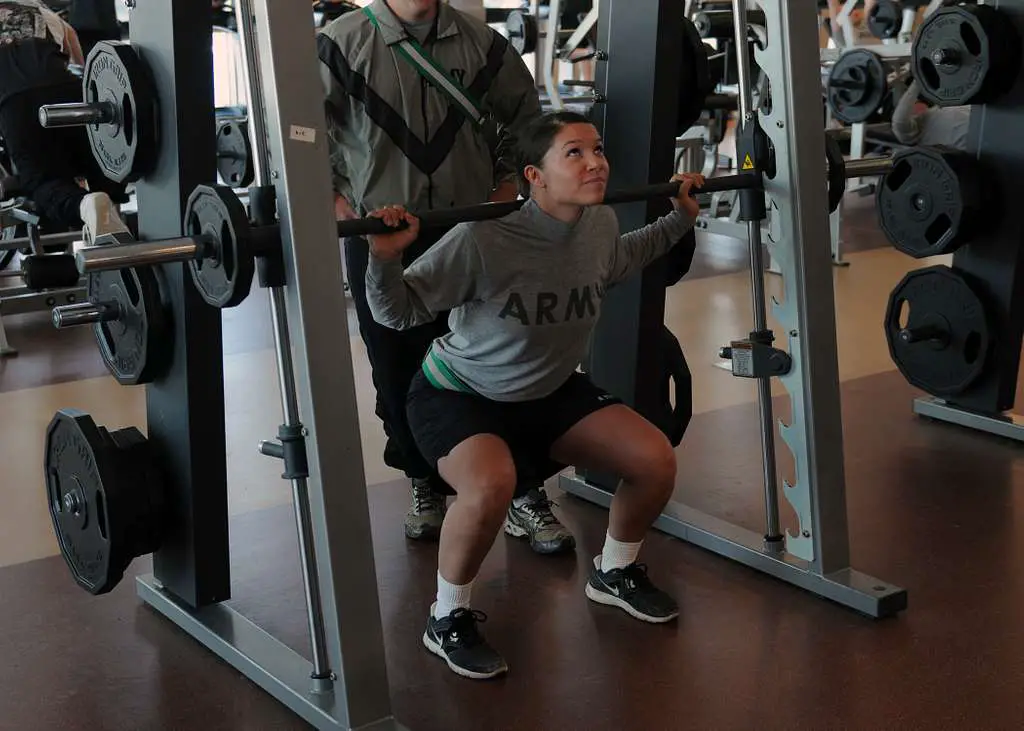U.S. Army Sgt. Melissa Schimmel uses a Smith machine to do a squat.
