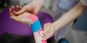 Kinesio Tape being applied on a wrist and forearm